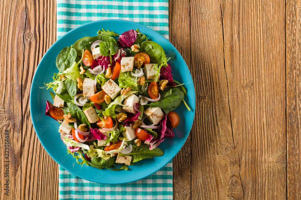 Delicious salad with tofu, tomatoes and walnuts. Delicious salad with tofu, tomatoes and walnuts.