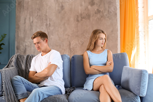 Young couple in quarrel sit...