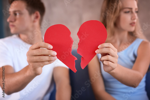 Young couple holding halves...
