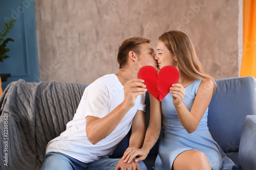Young couple connecting hal...