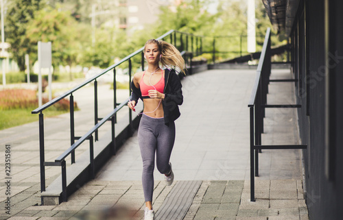 Morning run. Young blonde women.  On the move. © liderina