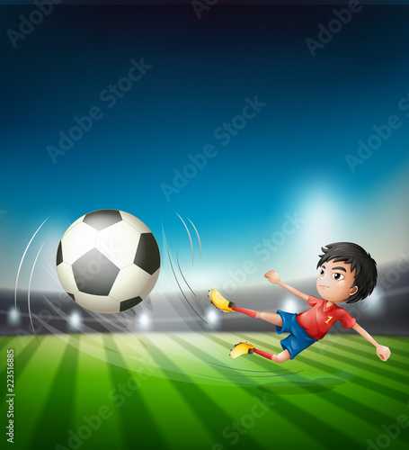 Obraz Piłkarz kopie piłkę
