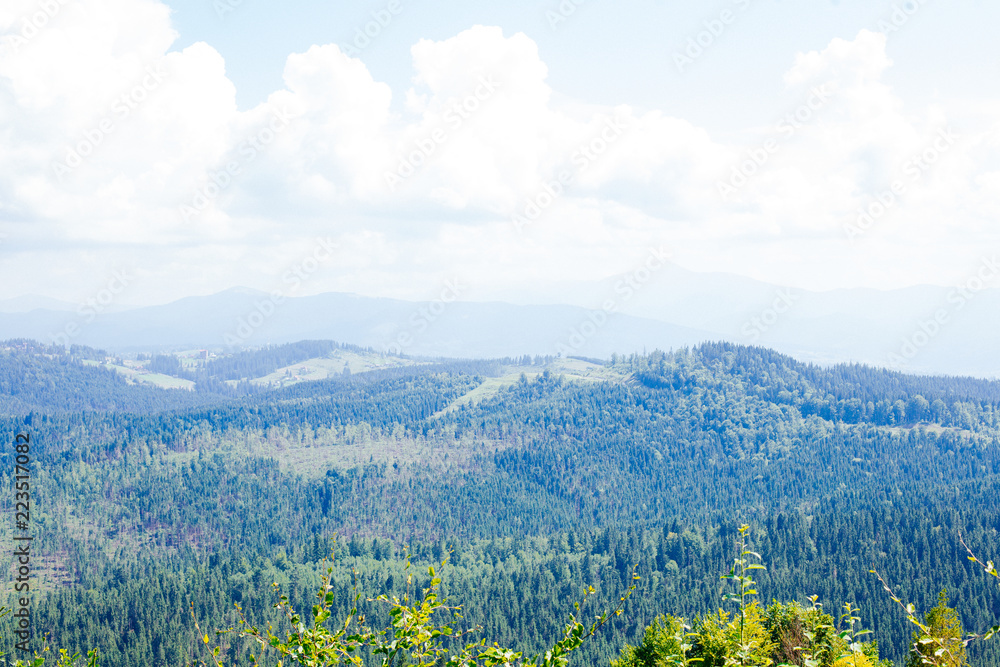 Summer mountain landscape. Landscape with mountains and green hills with blue sky and clouds.