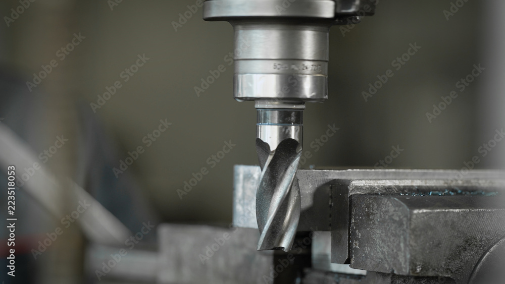 Close-up shot of a rotating drilling bit on machine in a industrial facility. Close-up shot of a rotating drilling bit on machine in a industrial facility.