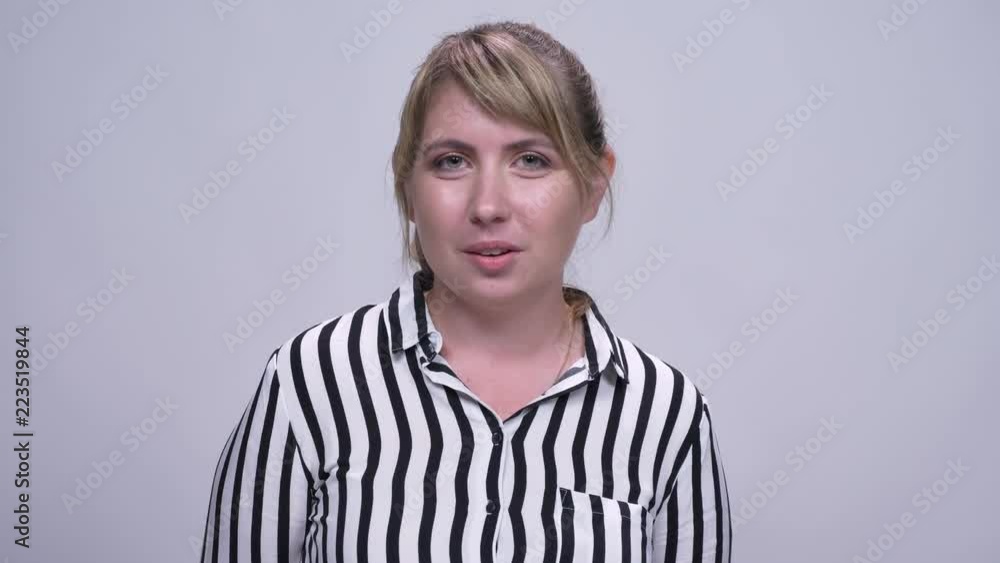 happy caucasian blond girl smiling in front of the camera on gray background happy caucasian blond girl smiling in front of the camera on gray background