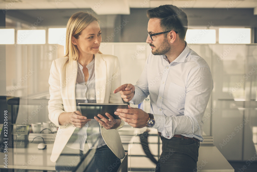 © liderina - Business woman showing something to her colleague on digital tablet.