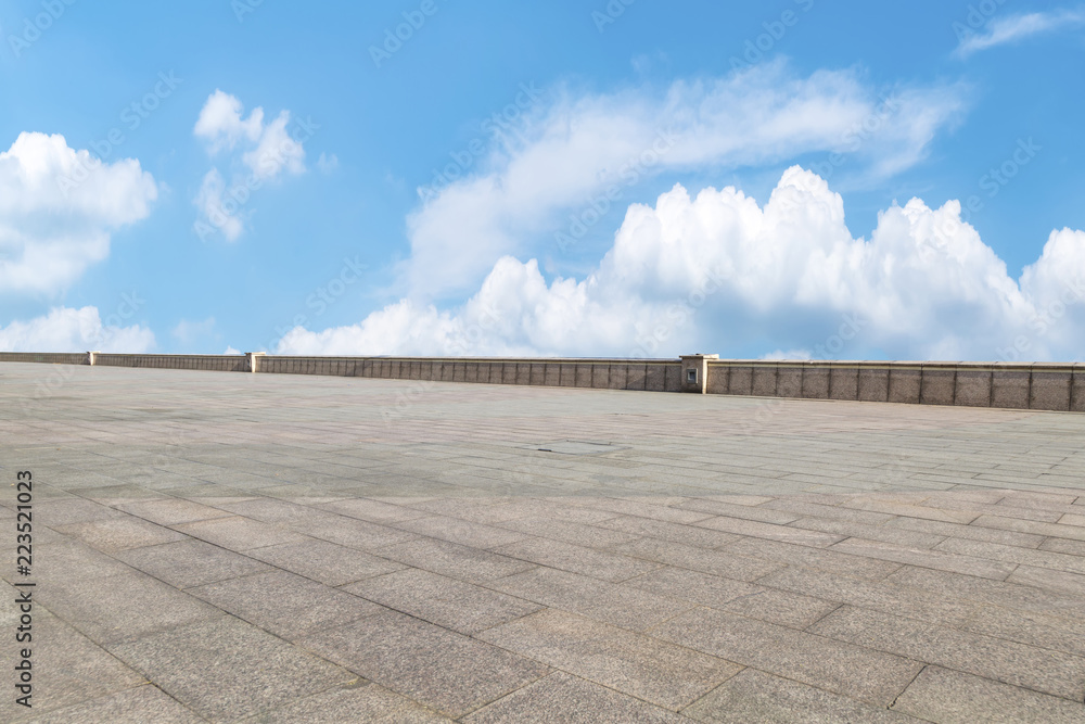 Empty stone floor under blue sky and white clouds Empty stone floor under blue sky and white clouds