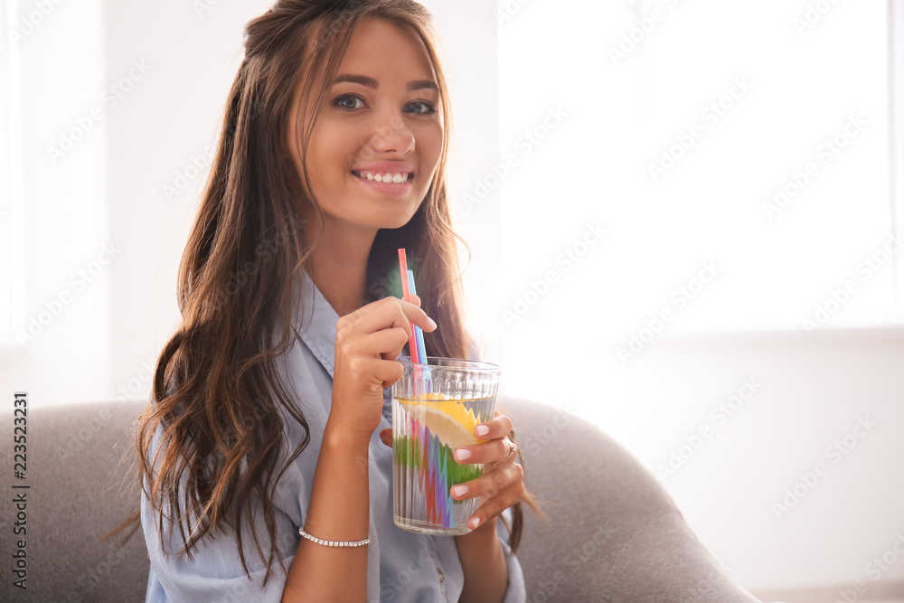 Young woman drinking fresh lemonade at home Young woman drinking fresh lemonade at home
