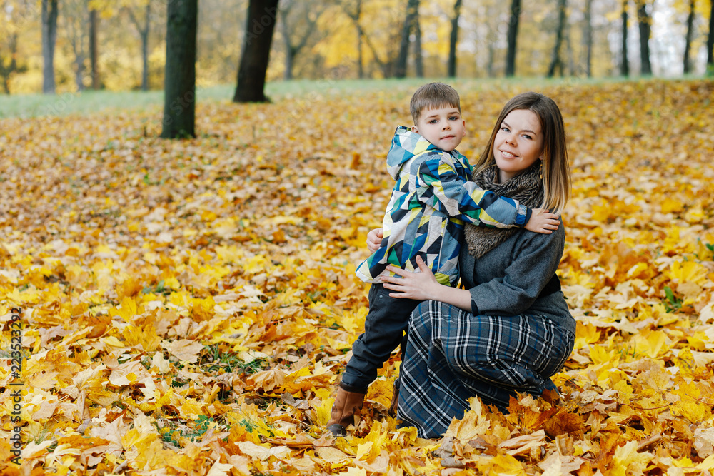 son hugs mother in autumn park son hugs mother in autumn park
