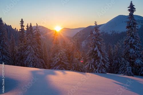 Magic sunset in the winter mountains after snowfall