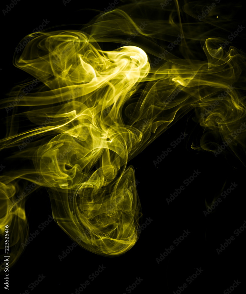 Fototapeta premium Yellow smoke on black background