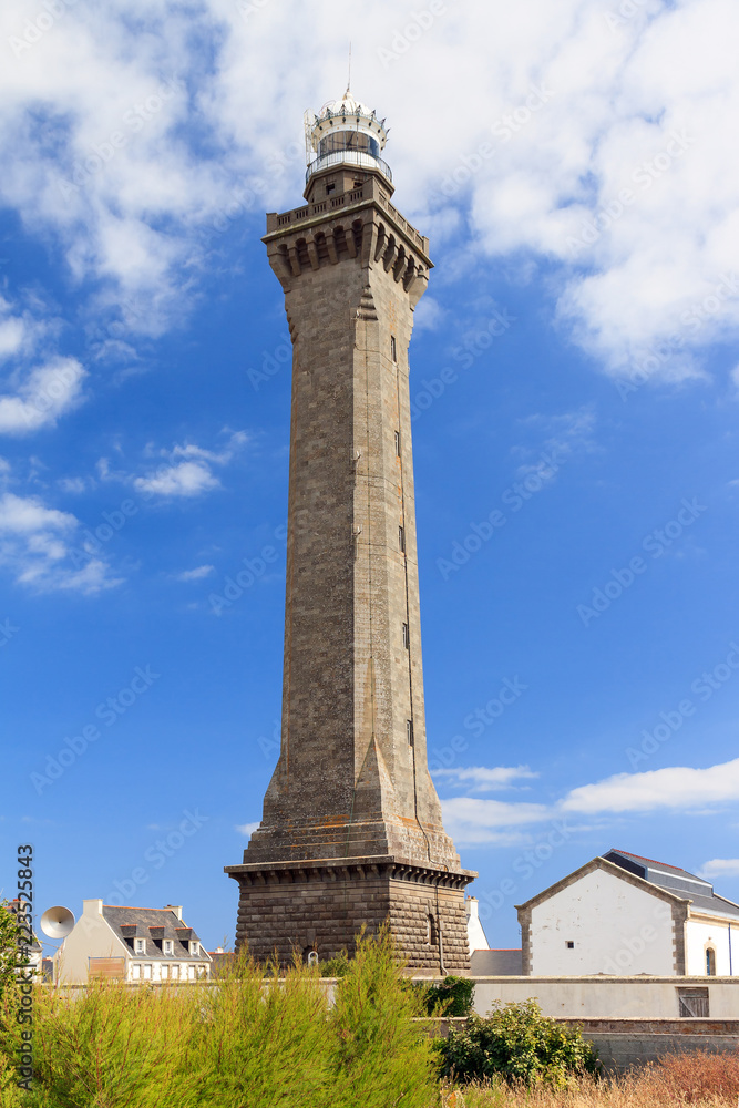 Fototapeta premium Beautiful view of the Eckmühl lighthouse (Phare d'Eckmühl, aka Point Penmarc'h Light or Saint-Pierre Light), in summer with a blue sky in Brittany (Bretagne), France 