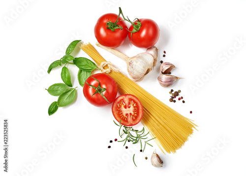 Spaghetti with tomatoes garlic and basil isolated on white background. Top view.