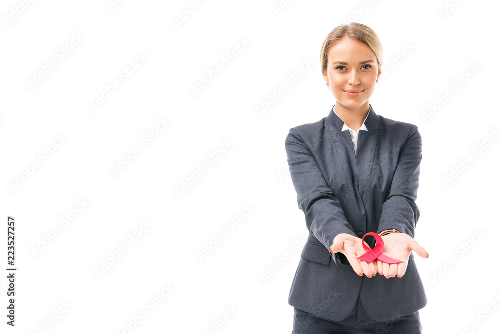 smiling young businesswoman holding aids awareness red ribbon symbol isolated on white smiling young businesswoman holding aids awareness red ribbon symbol isolated on white
