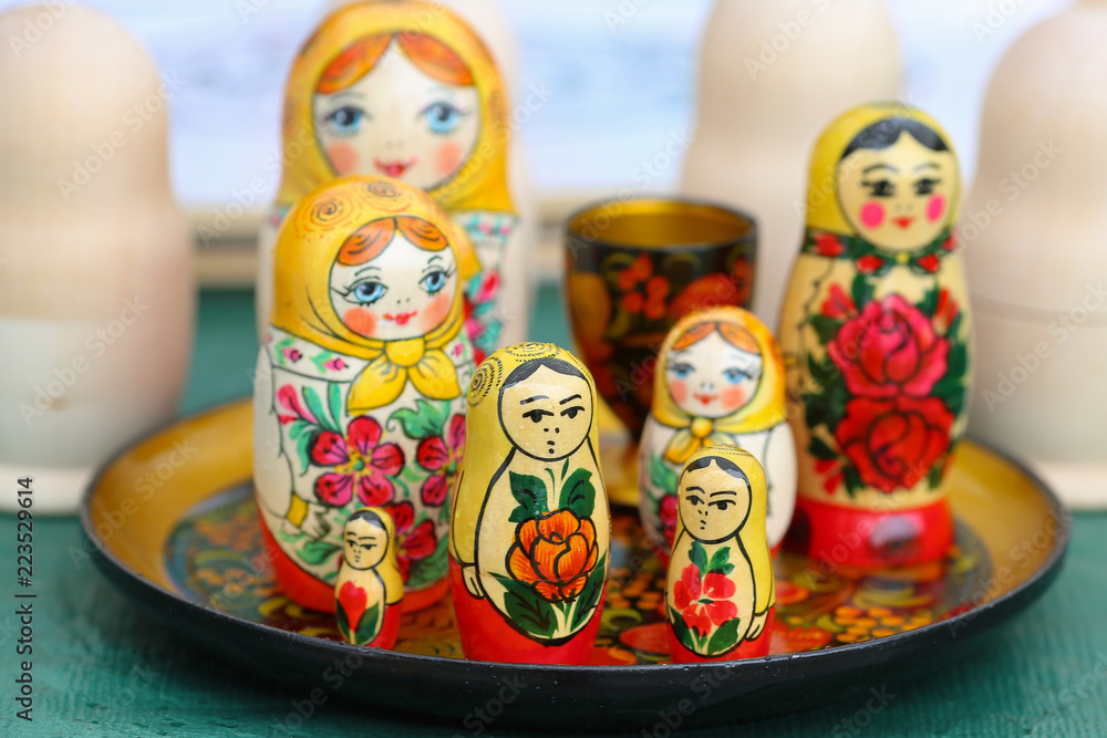 The russian doll Matryoshka with happy and angry faces, painted and not painted The russian doll Matryoshka with happy and angry faces, painted and not painted