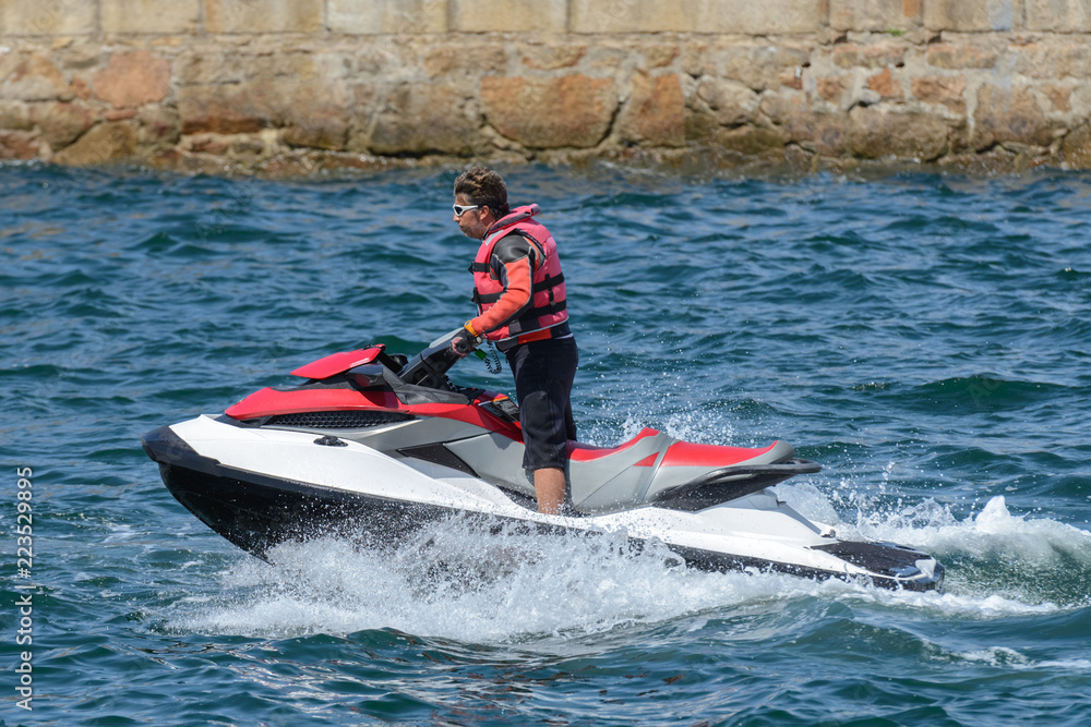 Obraz premium man is riding a hydrocycle