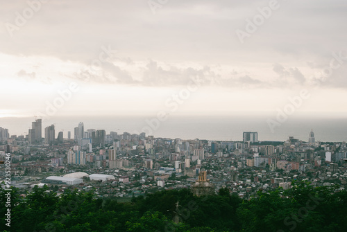 Beatiful colorful Georgian cityscape of Batumi. Panoramic view. Grey clouds over calm Black Sea
