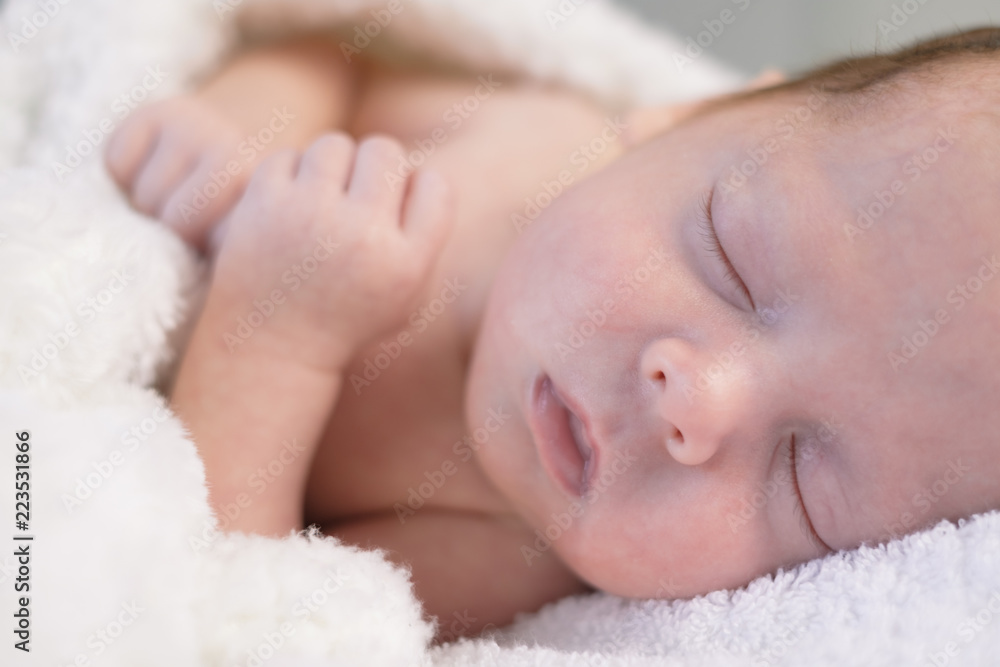 Newborn baby boy portrait on white carpet closeup. Motherhood and new life concept Newborn baby boy portrait on white carpet closeup. Motherhood and new life concept
