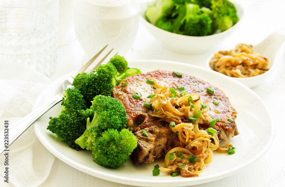 Fried pork steak with broccoli and onion sauce. Fried pork steak with broccoli and onion sauce.