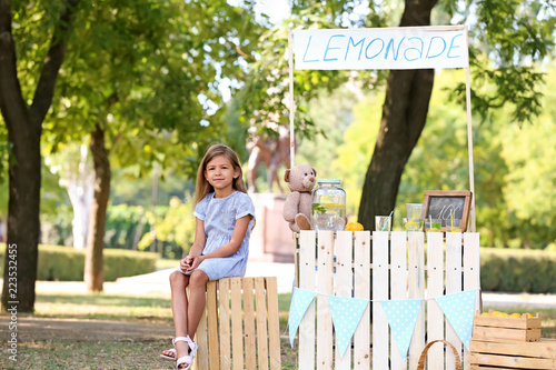 Little girl sitting on crat...