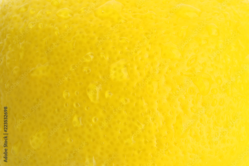 Texture of ripe lemon with water drops, closeup