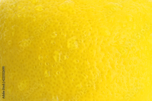 Texture of ripe lemon with water drops, closeup