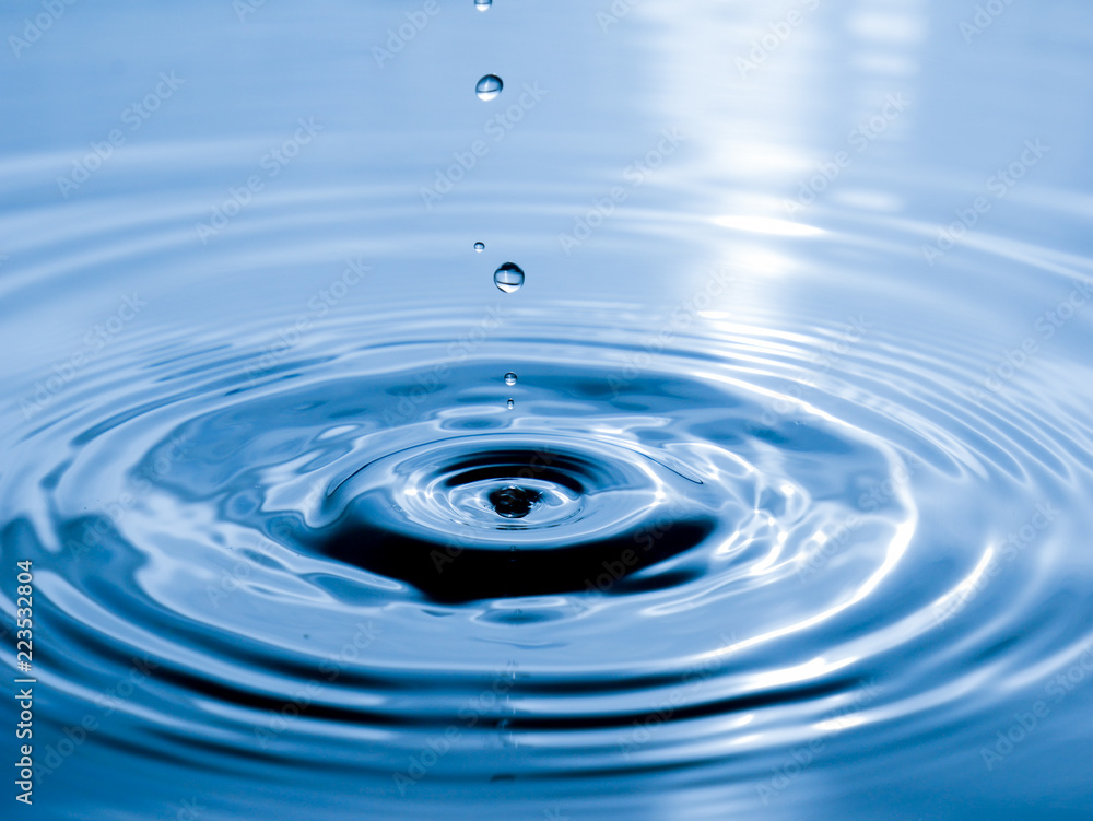 close up drop of water on blue background close up drop of water on blue background