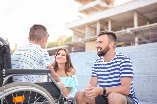Teenage boy in wheelchair w...