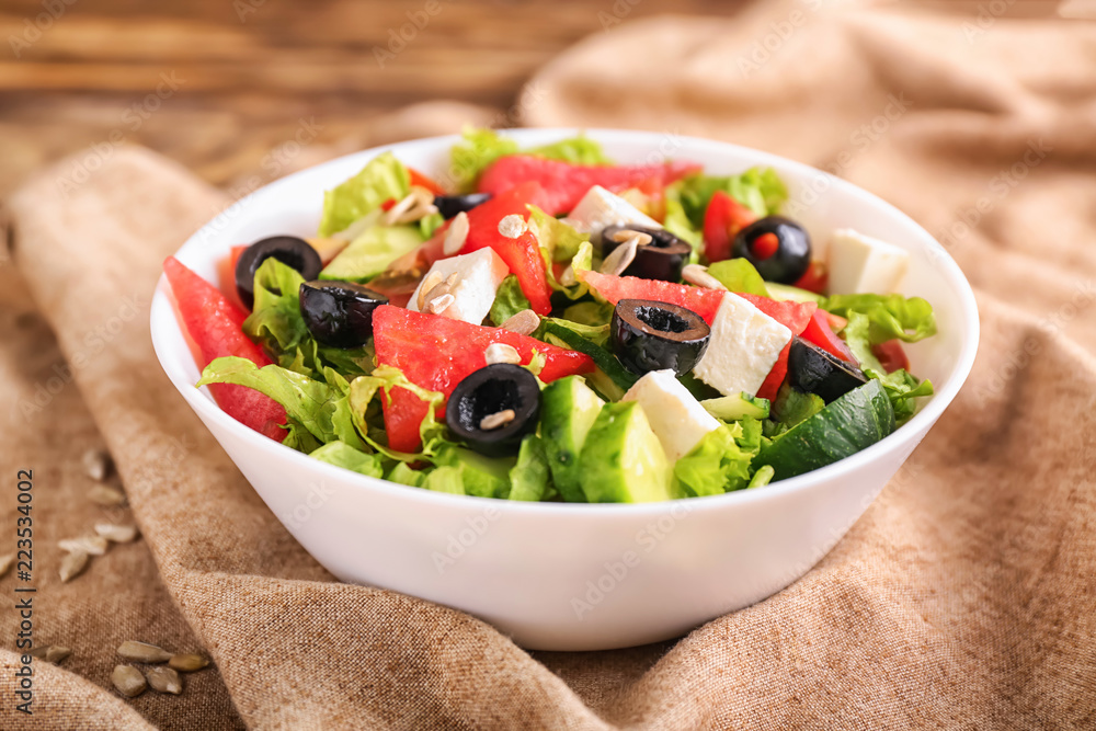 Bowl with delicious watermelon salad on table, closeup