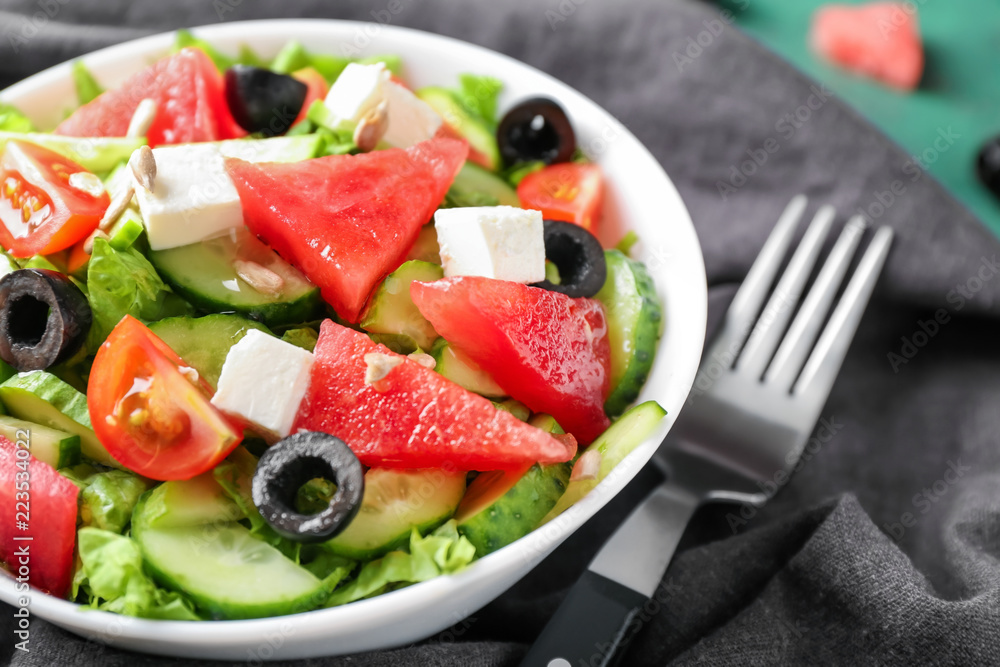 Bowl with delicious watermelon salad on table, closeup Bowl with delicious watermelon salad on table, closeup