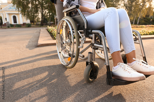 Young woman in wheelchair outdoors