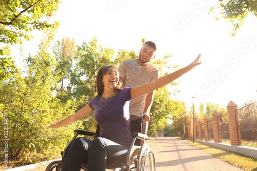 Happy young woman in wheelc...
