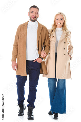 couple posing in trendy beige autumn coats, isolated on white