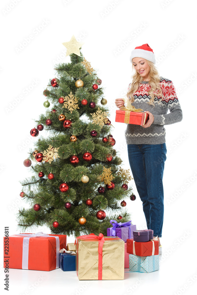 beautiful happy woman putting presents under christmas tree, isolated on white beautiful happy woman putting presents under christmas tree, isolated on white