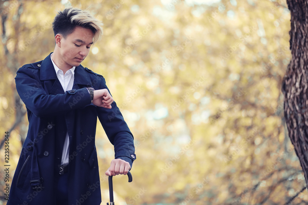 Autumn rainy weather and a young man with an umbrella Autumn rainy weather and a young man with an umbrella