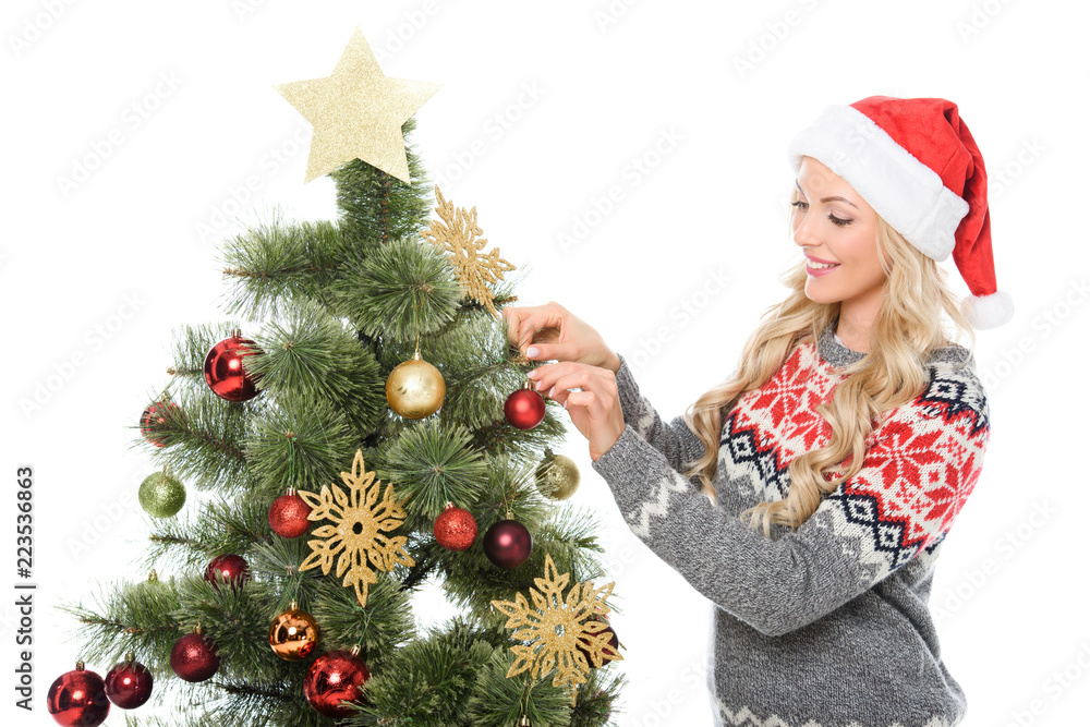 attractive woman decorating christmas tree, isolated on white