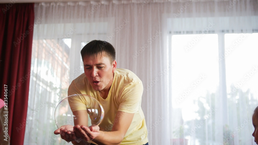 Artist holding big soap bubble in his hands Artist holding big soap bubble in his hands