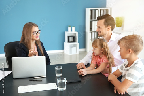 Young man and his children meeting with headmistress at school
