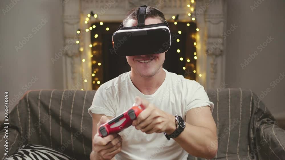 Male gamer playing video game in virtual reality headset Male gamer playing video game in virtual reality headset