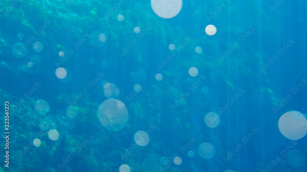 Bright blue background of water with lens flares Bright blue background of water with lens flares