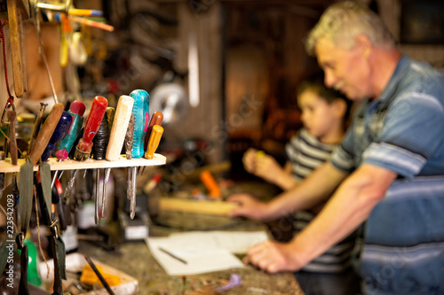 фотографія grandfather and grandson work with tools