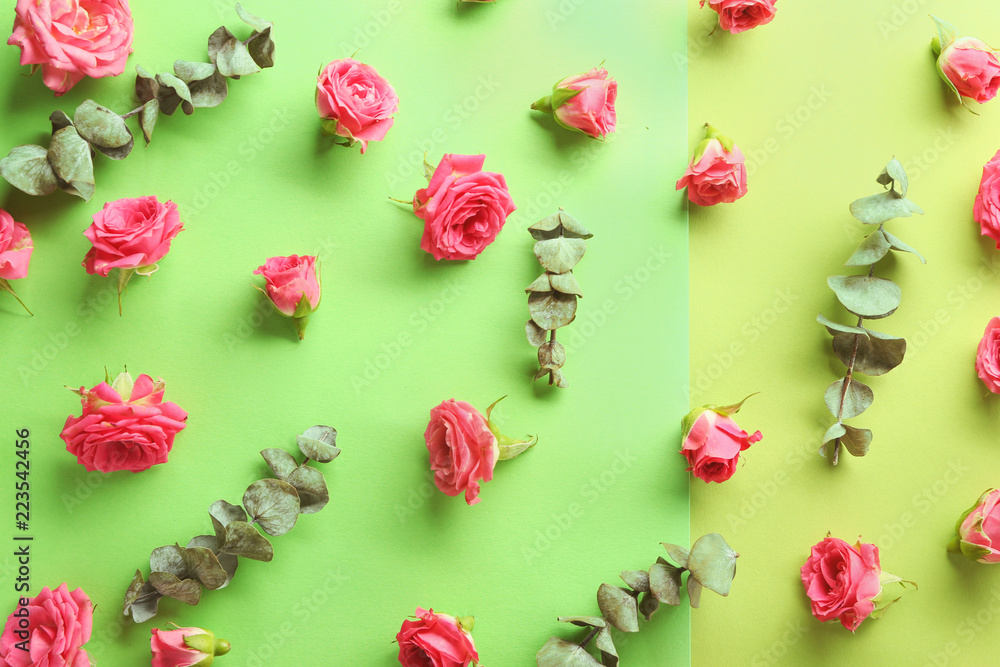 Composition with beautiful flowers and eucalyptus leaves on color background Composition with beautiful flowers and eucalyptus leaves on color background