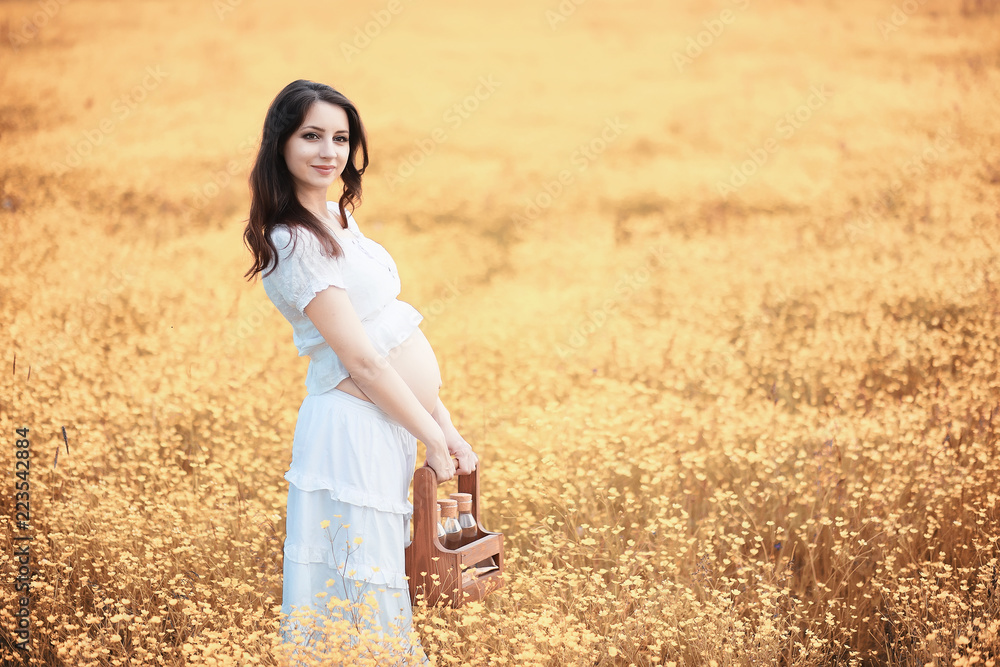 Pregnant woman in nature for a walk in the autumn Pregnant woman in nature for a walk in the autumn