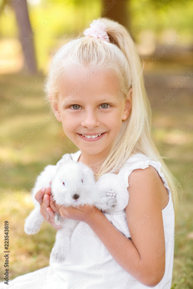 Little girl with cute rabbit outdoors Little girl with cute rabbit outdoors
