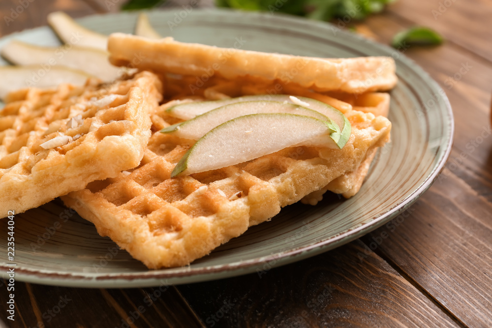 Delicious waffles with pear slices on plate Delicious waffles with pear slices on plate