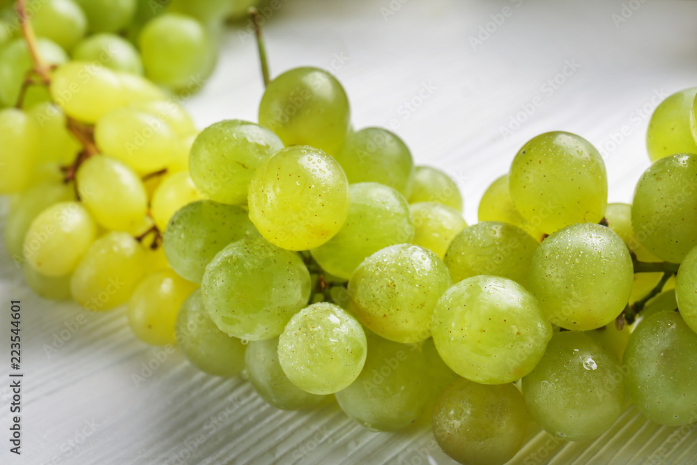 Ripe sweet grapes on white wooden table, closeup Ripe sweet grapes on white wooden table, closeup