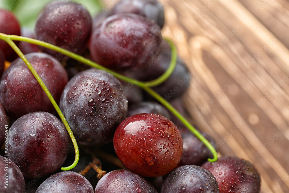 Ripe sweet grapes on wooden table, closeup Ripe sweet grapes on wooden table, closeup