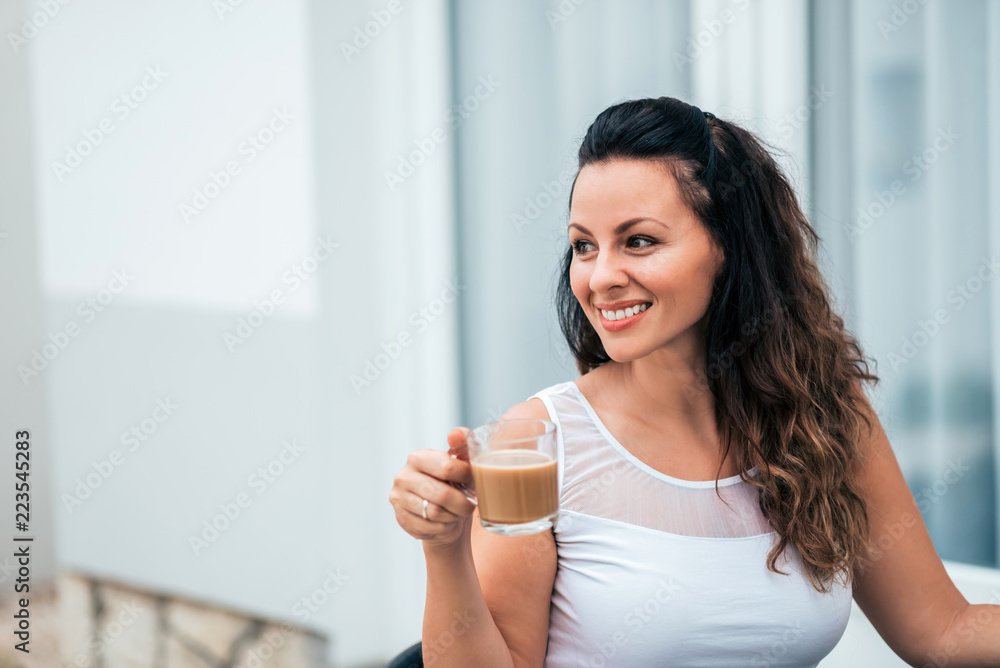 Close-up portrait of smiling young woman with a drink. Close-up portrait of smiling young woman with a drink.