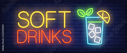 Soft drinks neon sign. Glass of lemonade with ice cube on brick wall background. Vector illustration in neon style for family cafe and restaurant