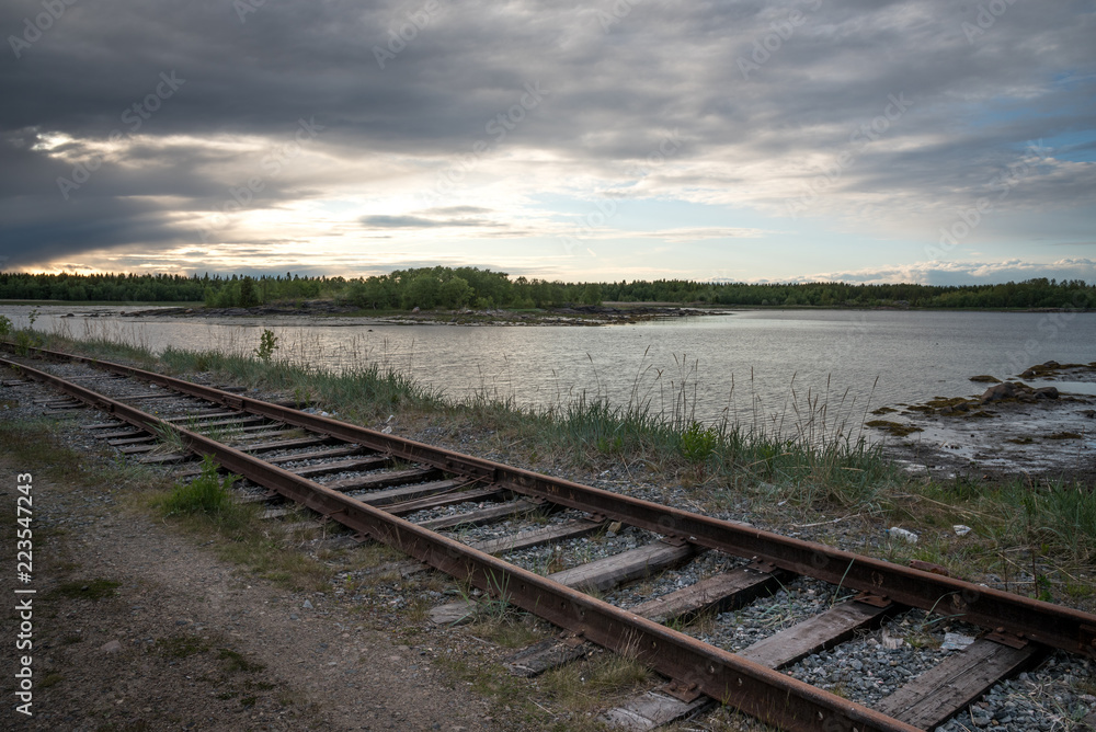 old railroad tracks along the lake